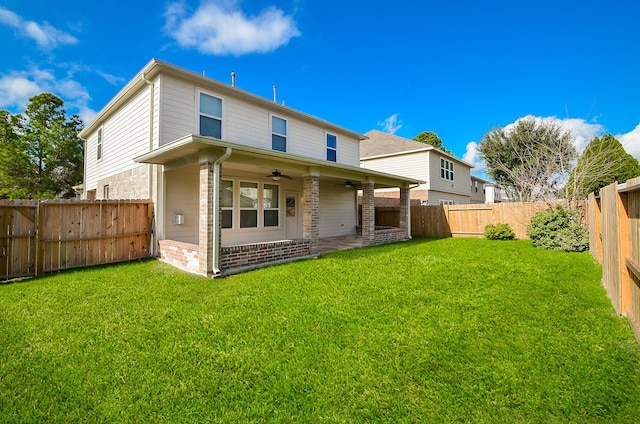 back of house featuring a yard, a patio area, and ceiling fan