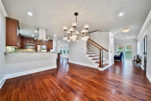 kitchen with crown molding, stainless steel appliances, light stone countertops, dark hardwood / wood-style flooring, and kitchen peninsula