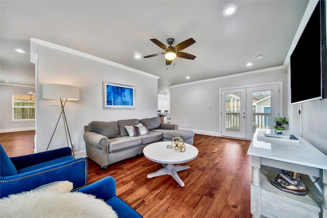 living room with wood-type flooring, ornamental molding, and french doors