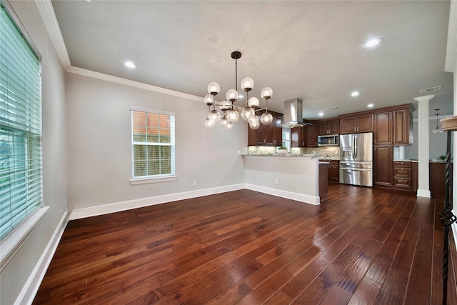 kitchen with island range hood, appliances with stainless steel finishes, kitchen peninsula, light stone countertops, and backsplash