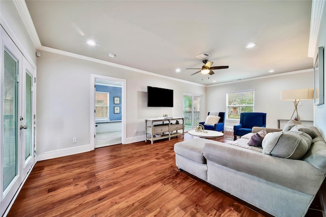 living room with ornamental molding, hardwood / wood-style floors, and ceiling fan