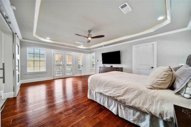 bedroom featuring french doors, crown molding, access to outside, dark hardwood / wood-style floors, and a raised ceiling