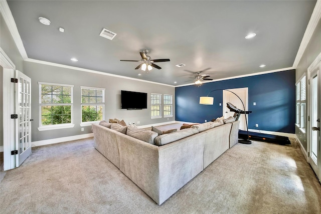 carpeted living room featuring crown molding, french doors, and ceiling fan