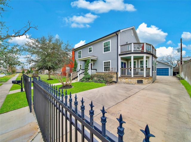 view of front of home with a porch, a garage, a balcony, an outdoor structure, and a front lawn