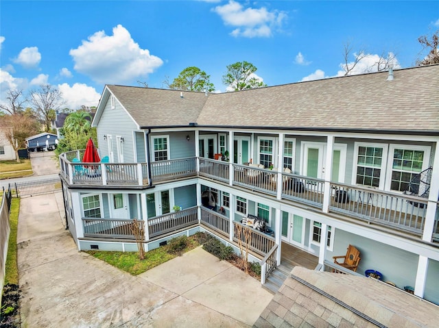 back of house featuring french doors and a balcony