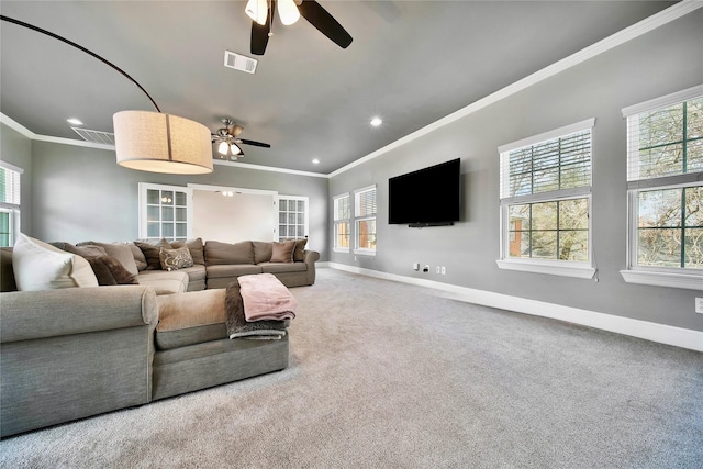 carpeted living room with ceiling fan and ornamental molding