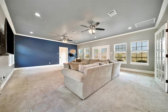 carpeted living room featuring french doors, ceiling fan, and crown molding