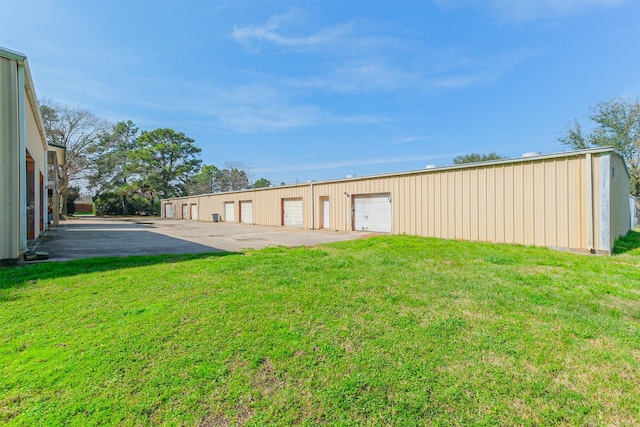 exterior space with a yard and a garage