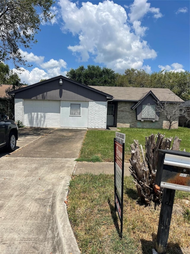 single story home featuring a garage and a front yard