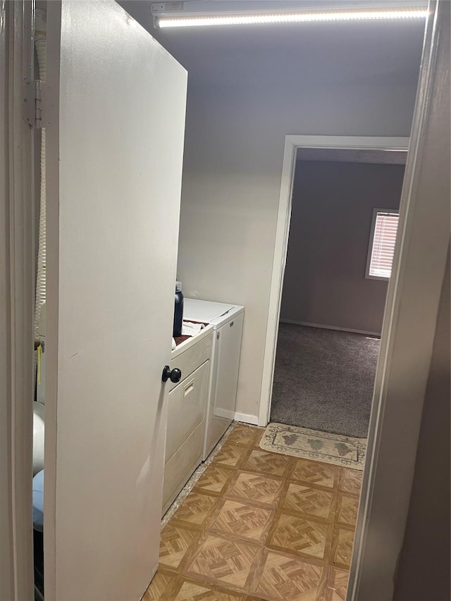 laundry area featuring light parquet flooring and washer and dryer