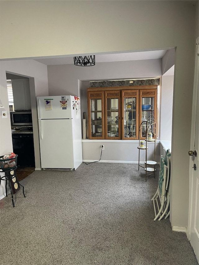 interior space featuring carpet floors and white refrigerator