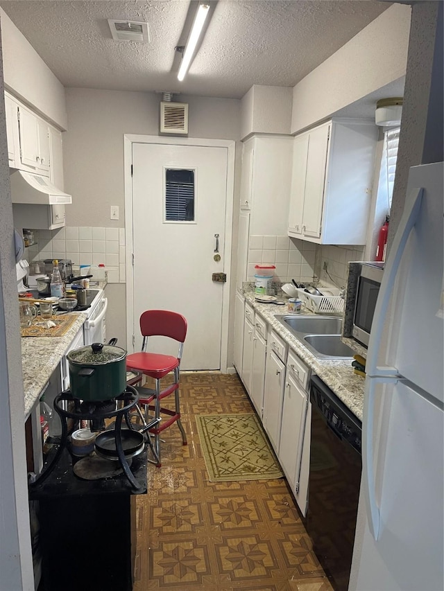 kitchen featuring sink, a textured ceiling, white refrigerator, dishwasher, and white cabinets