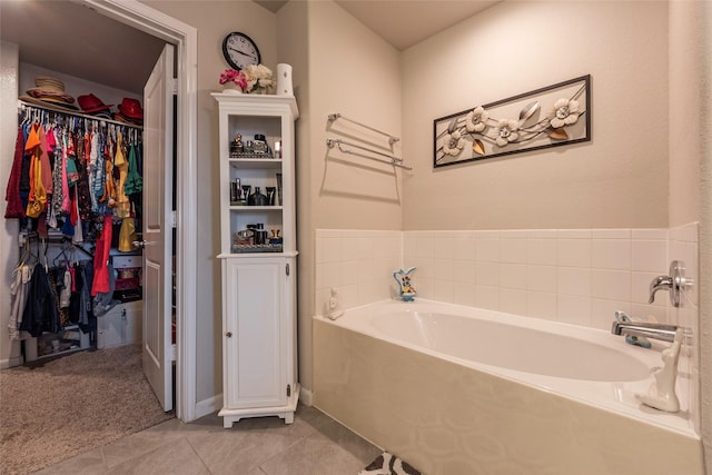 bathroom featuring a bath and tile patterned flooring