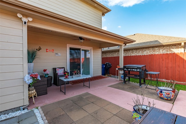 view of patio with area for grilling and ceiling fan