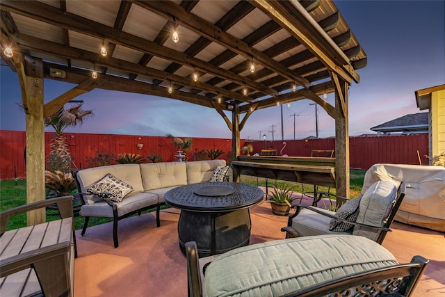 patio terrace at dusk featuring an outdoor living space with a fire pit