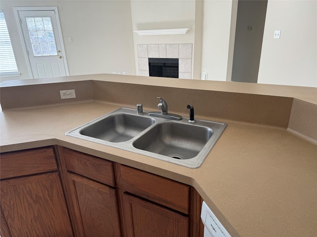 kitchen featuring sink and a fireplace