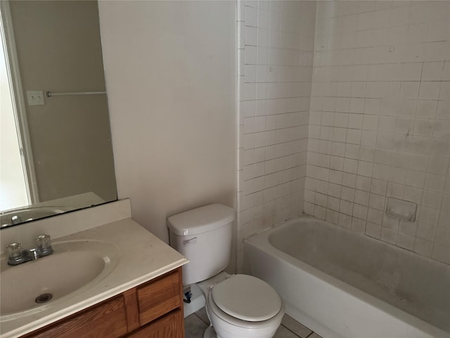 full bathroom with tiled shower / bath, vanity, and toilet