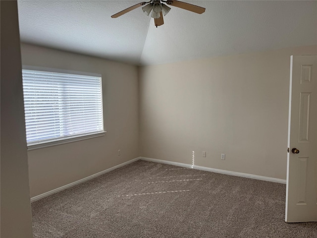 unfurnished room featuring lofted ceiling, carpet floors, and ceiling fan