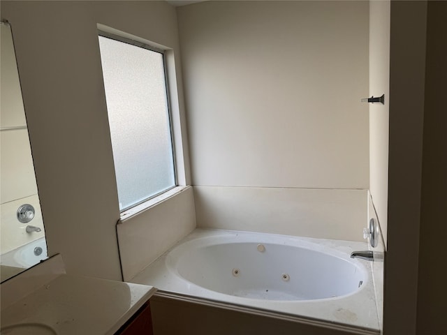 bathroom featuring vanity and a washtub