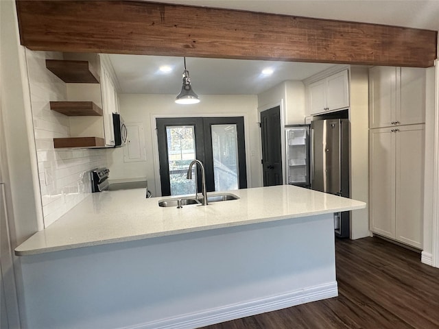 kitchen featuring sink, kitchen peninsula, and appliances with stainless steel finishes