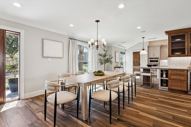 dining room featuring a healthy amount of sunlight, dark wood-type flooring, and ornamental molding