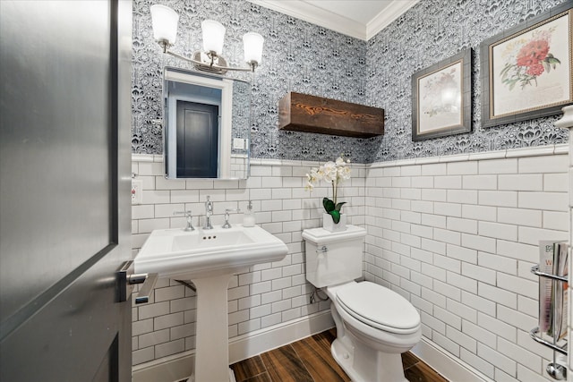 bathroom with tile walls, wood-type flooring, ornamental molding, and toilet