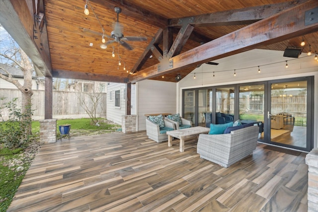 wooden terrace with ceiling fan and an outdoor living space