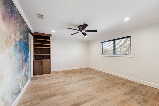 empty room featuring crown molding and light hardwood / wood-style flooring