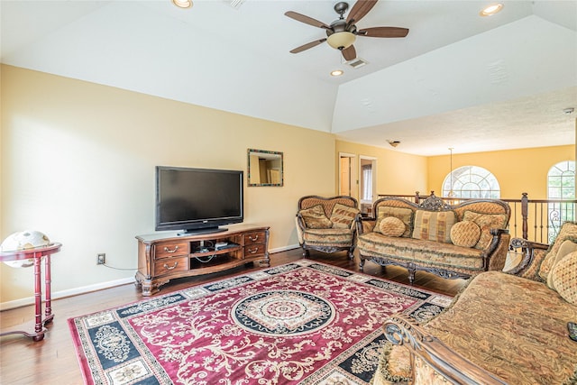 living room with lofted ceiling, hardwood / wood-style floors, and ceiling fan