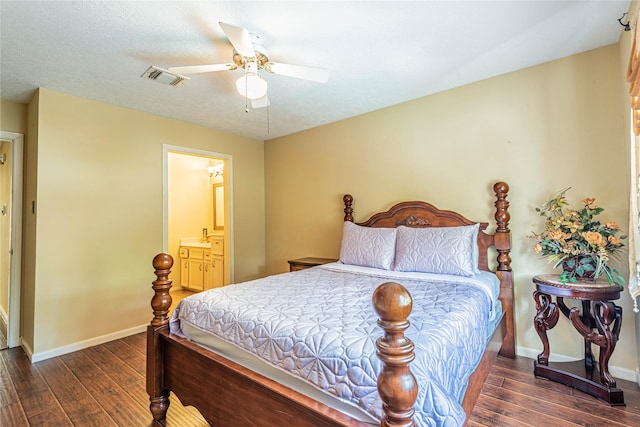 bedroom featuring connected bathroom, dark wood-type flooring, a textured ceiling, and ceiling fan