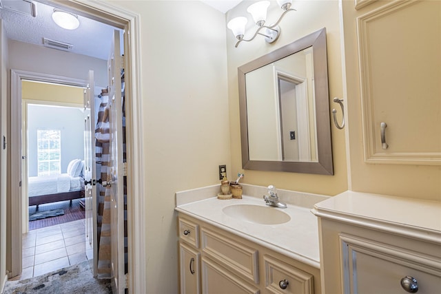 bathroom featuring vanity, tile patterned flooring, and a textured ceiling