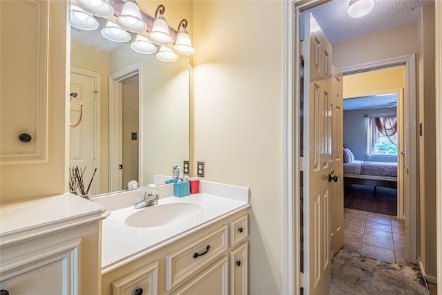 bathroom with vanity, tile patterned floors, and a textured ceiling