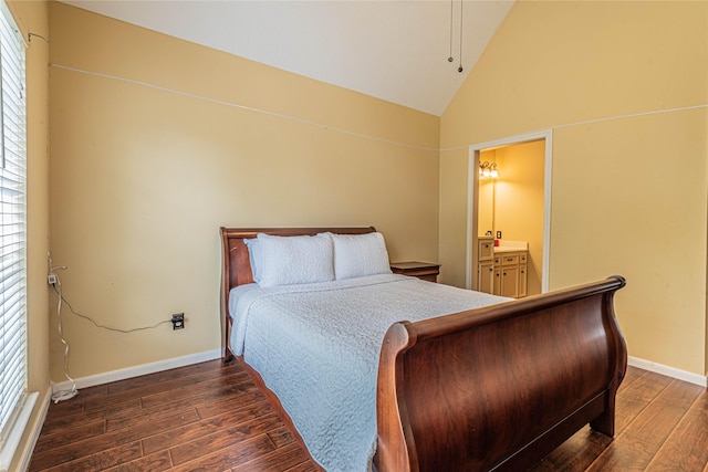 bedroom with dark hardwood / wood-style flooring, ensuite bath, and high vaulted ceiling