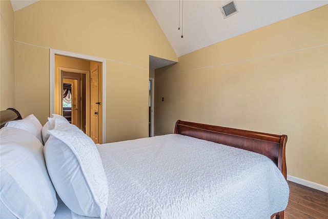 bedroom with vaulted ceiling and dark hardwood / wood-style floors