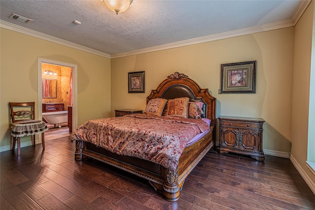 bedroom featuring dark hardwood / wood-style flooring, connected bathroom, ornamental molding, and a textured ceiling