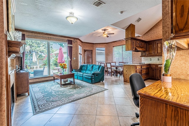 living room with ceiling fan, lofted ceiling, a textured ceiling, and light tile patterned floors