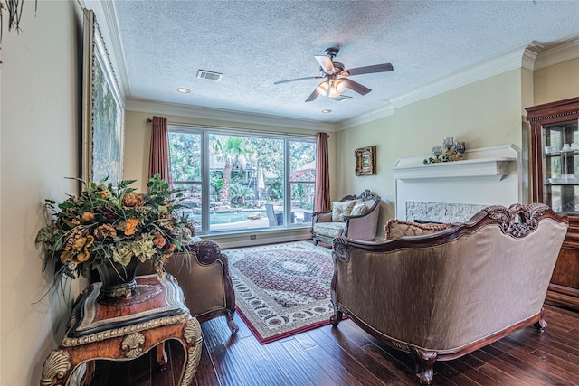 living room featuring crown molding, a textured ceiling, dark hardwood / wood-style floors, and ceiling fan