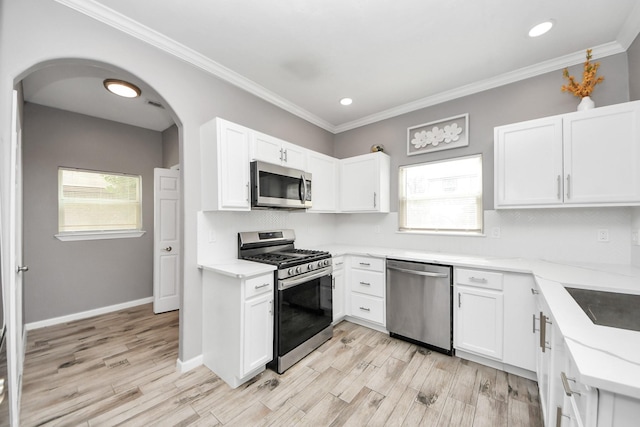 kitchen featuring white cabinetry, stainless steel appliances, and a healthy amount of sunlight