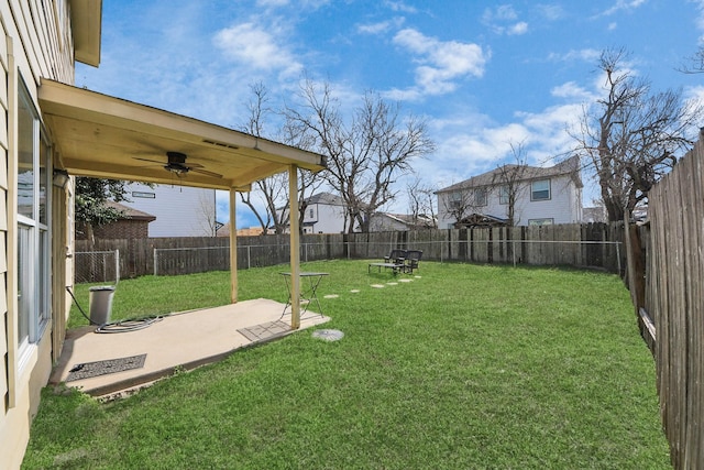 view of yard with a patio and ceiling fan