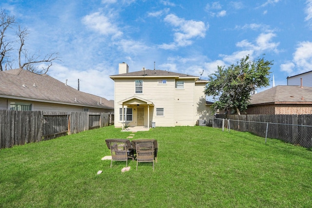 back of property featuring a yard