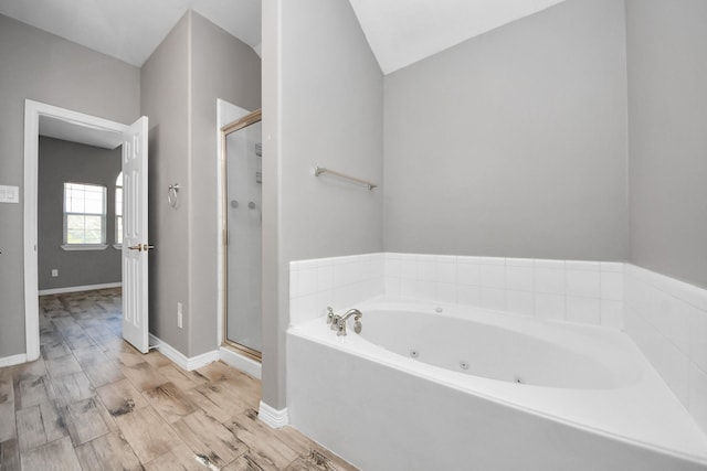 bathroom with shower with separate bathtub and hardwood / wood-style floors