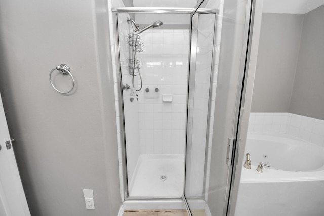 bathroom with shower with separate bathtub