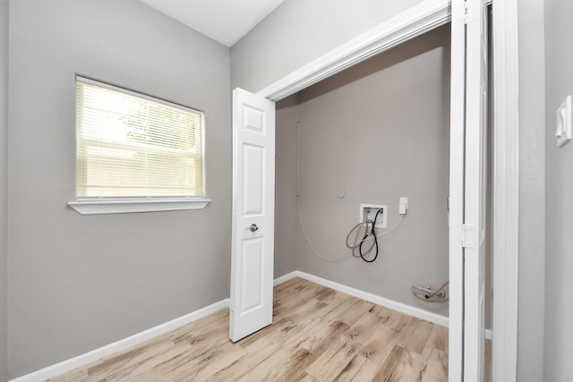 washroom with washer hookup and light hardwood / wood-style flooring