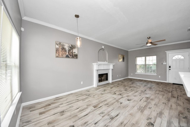 unfurnished living room with crown molding, ceiling fan, and light hardwood / wood-style floors