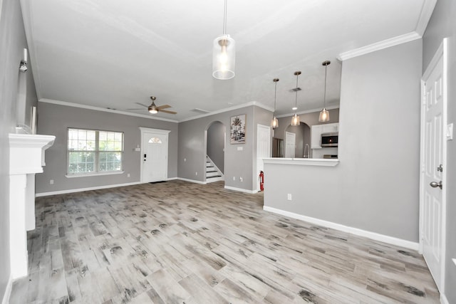 unfurnished living room featuring crown molding, ceiling fan, and light hardwood / wood-style flooring