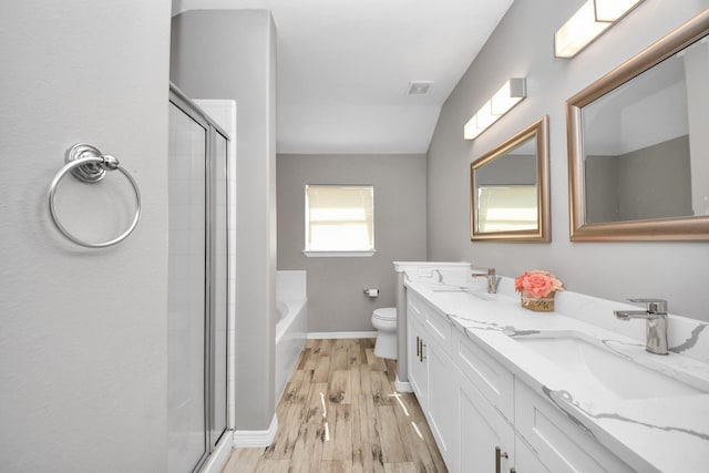 full bathroom with plus walk in shower, wood-type flooring, vanity, and toilet