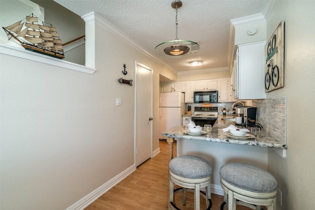 kitchen featuring light wood-type flooring, white refrigerator, kitchen peninsula, electric stove, and white cabinets