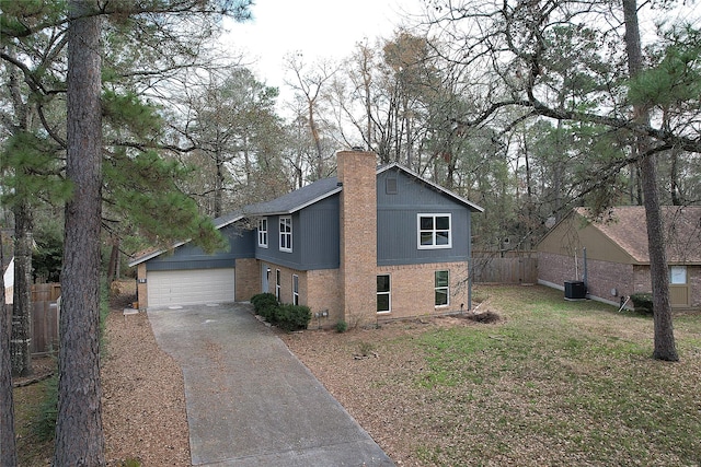 view of side of property with a garage and central air condition unit