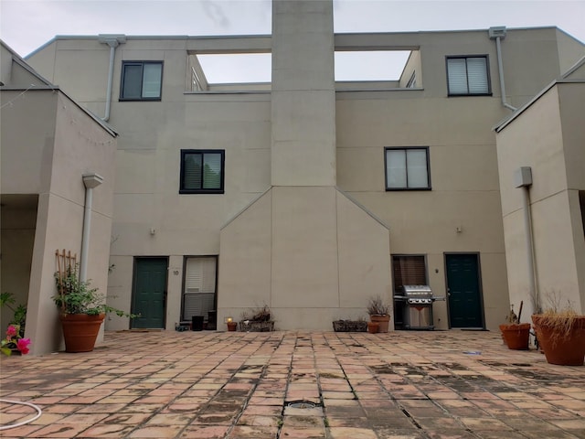 back of property featuring a patio area