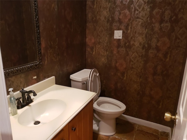 bathroom with tile patterned flooring, vanity, and toilet